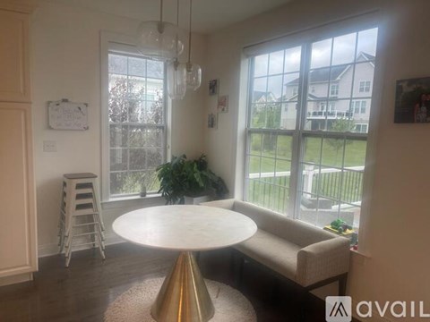 A living room with a white table and a couch.