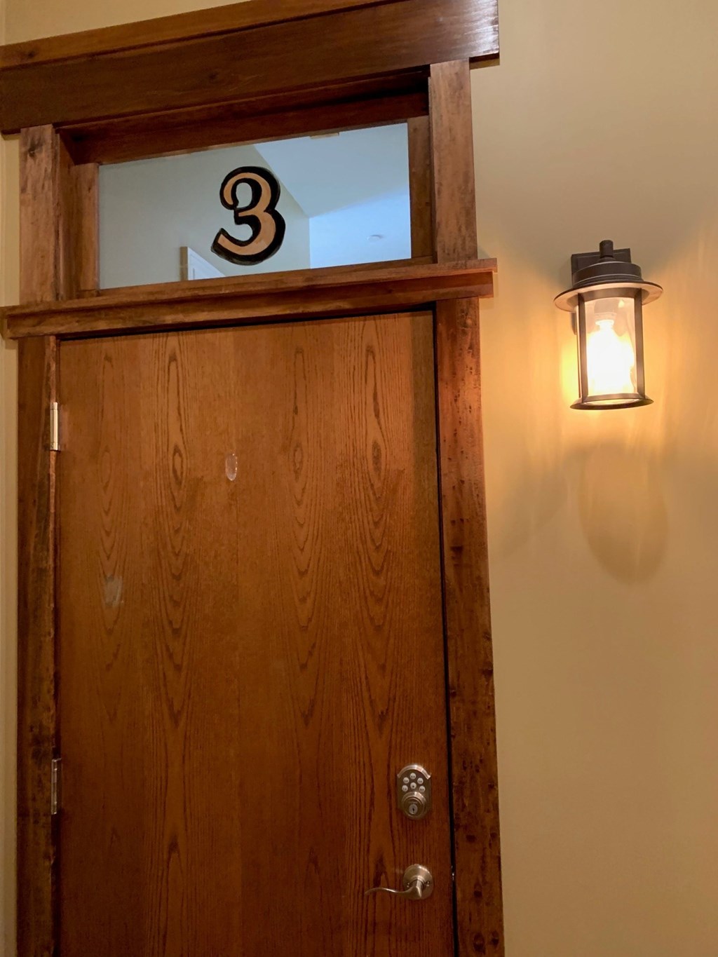 A brown door with a number 3 on it.