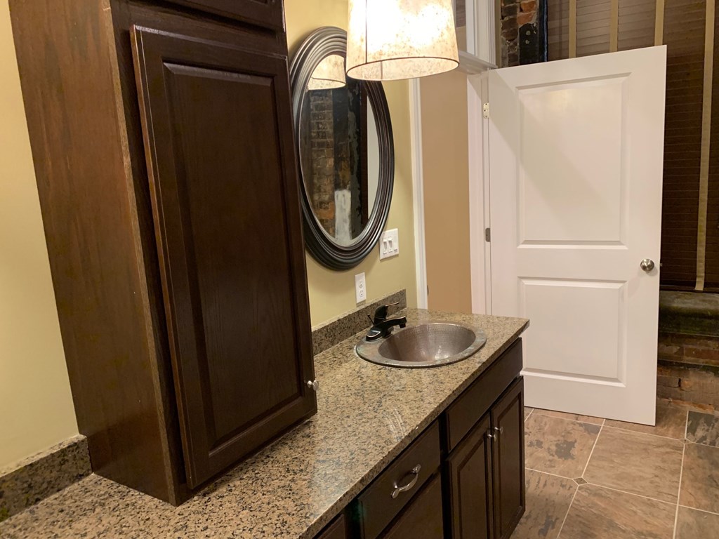 A bathroom with a sink and a mirror.