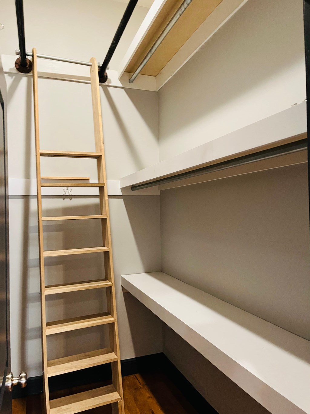 A wooden ladder is leaning against a wall in a room.