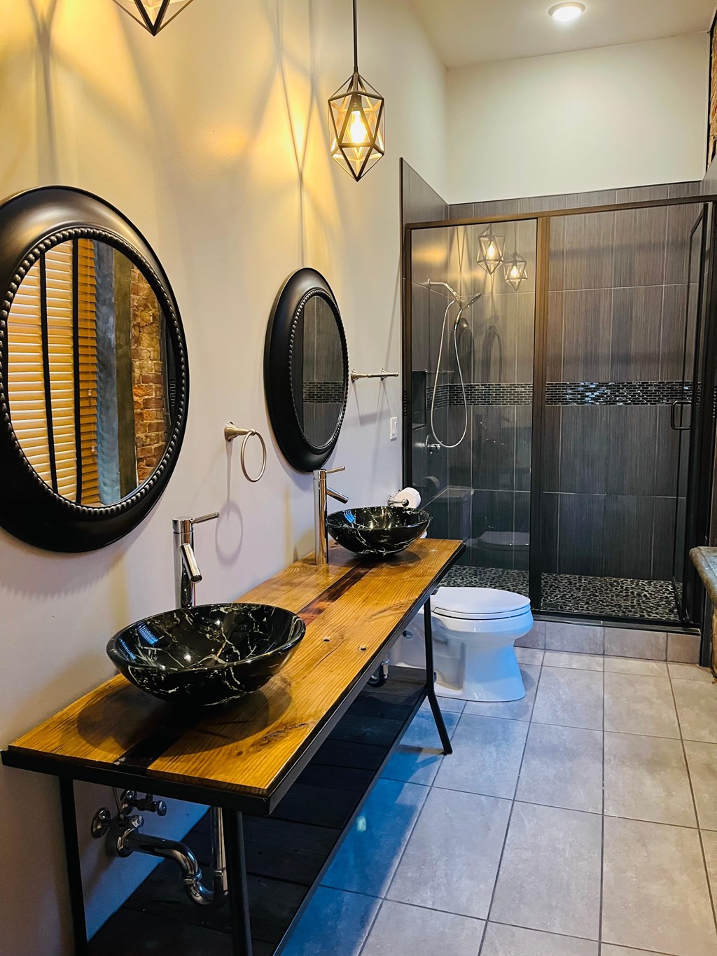 A bathroom with a wooden counter and a white toilet.