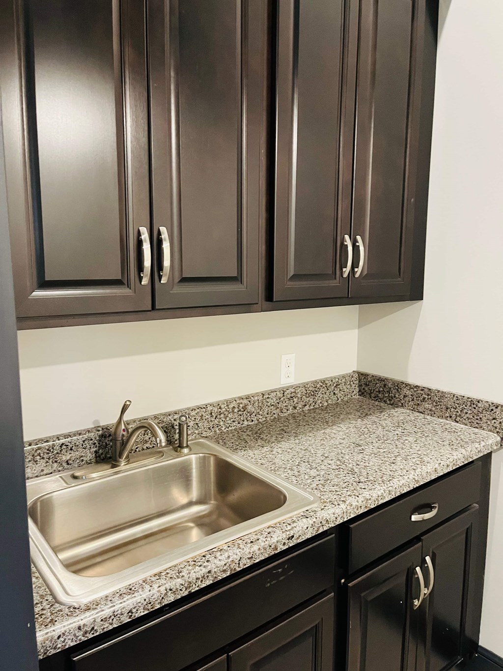 A kitchen with a sink and cabinets.