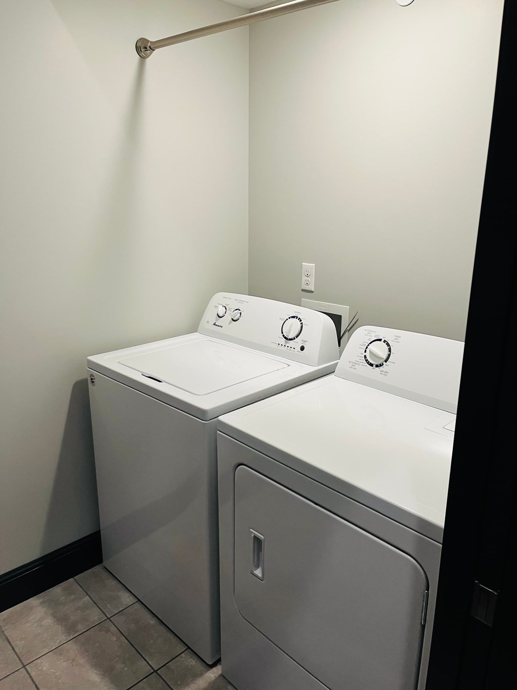 Two washing machines in a laundry room.