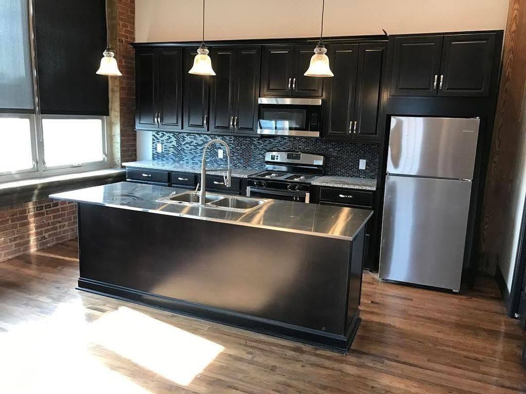 A modern kitchen with a large island in the center.