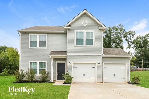 A two-story house with a garage is for sale by FirstKey Homes.