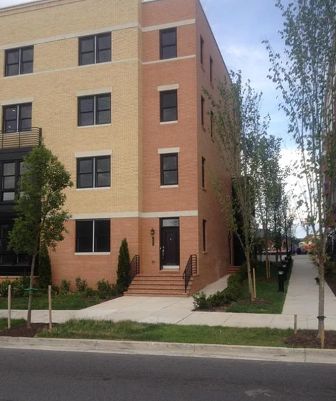 A building with a red brick facade and a black door.