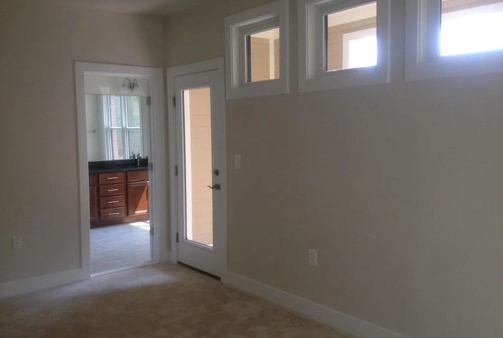 A room with a doorway leading to another room.