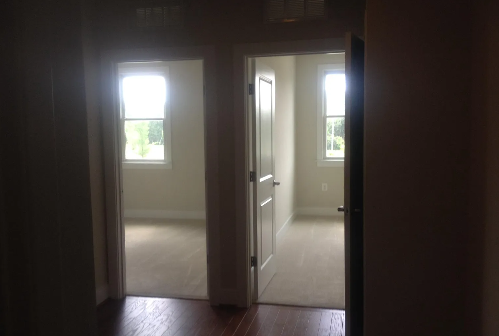 A hallway with two doors leading to other rooms.