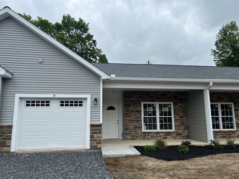 A house with a white garage door and a brick facade.