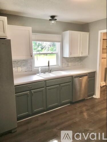 A kitchen with a sink and a window.