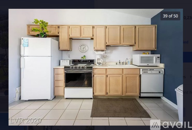 A kitchen with wooden cabinets and white appliances.