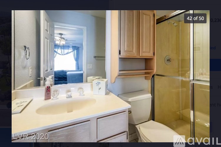 A bathroom with a sink, toilet, and shower.