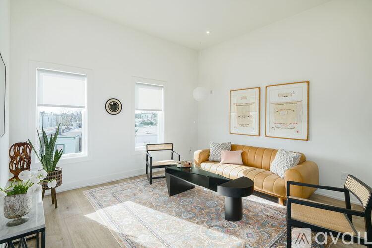 A living room with a sofa, a coffee table, and a rug.