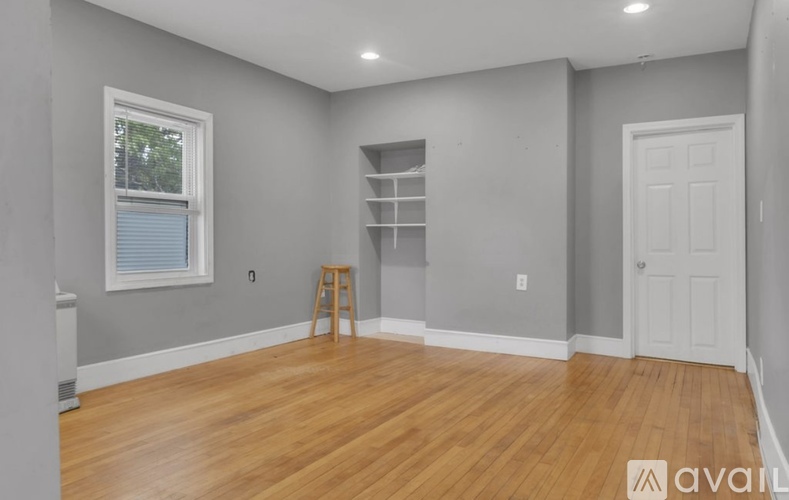 A room with wooden floors and a white door.