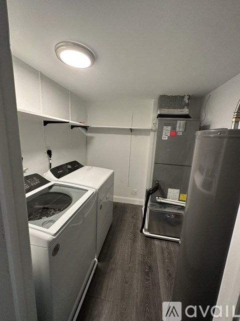 A small kitchen with a fridge, dishwasher and a stove.