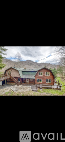 A house with a mountain in the background is for sale.