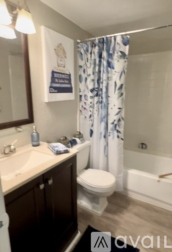 A bathroom with a toilet, sink, and shower.