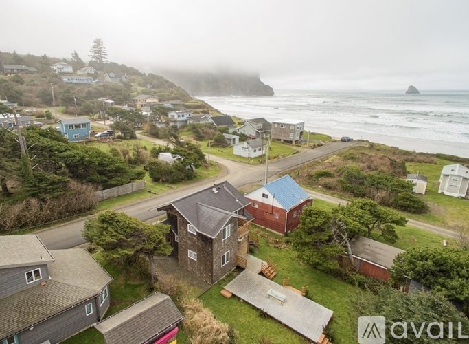 A coastal neighborhood with houses and a view of the ocean.
