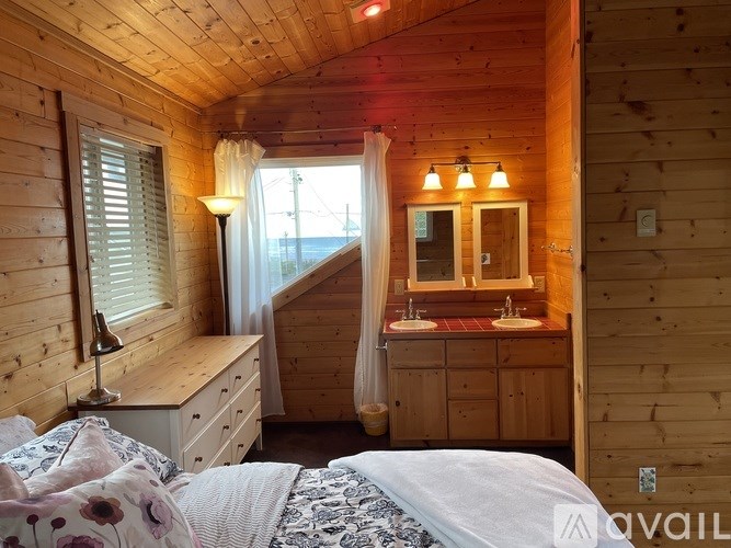 A bedroom with a bed, dresser, and mirror.