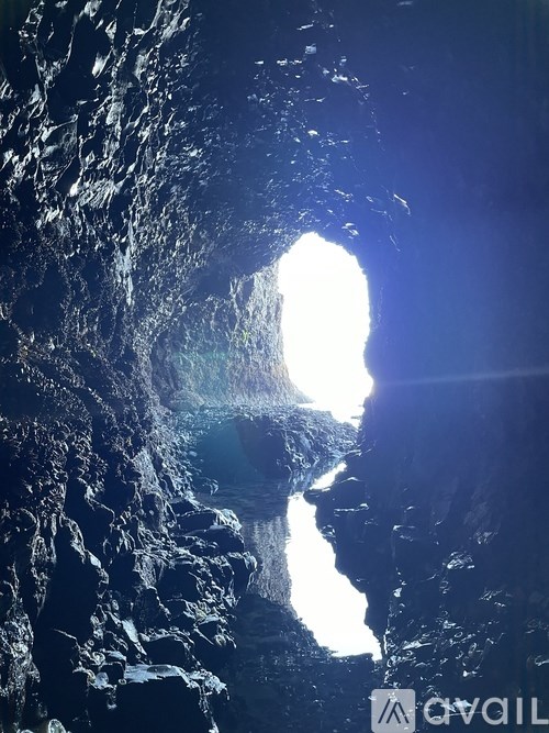 A cave with a bright light at the end.