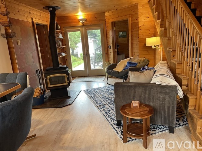 A living room with a grey couch and a wooden coffee table.