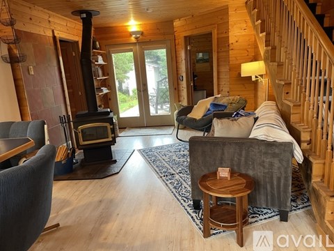 A living room with a grey couch and a wooden coffee table.