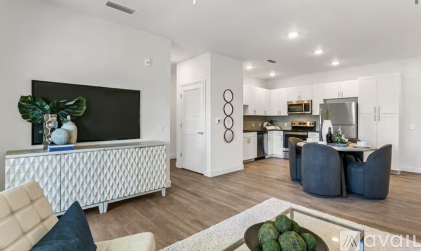 A modern living room with a white sofa and a television.