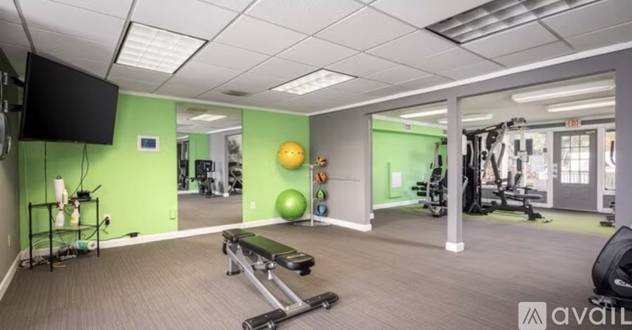 A living room with a couch, a coffee table, and a television.