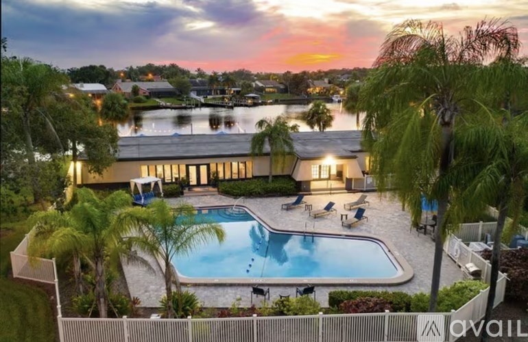 A kitchen with white cabinets and a black countertop.