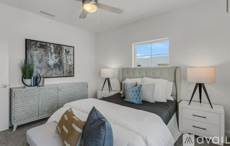 A bedroom with a large bed, a radiator, and a painting on the wall.