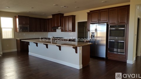 A kitchen with brown cabinets and a white island.