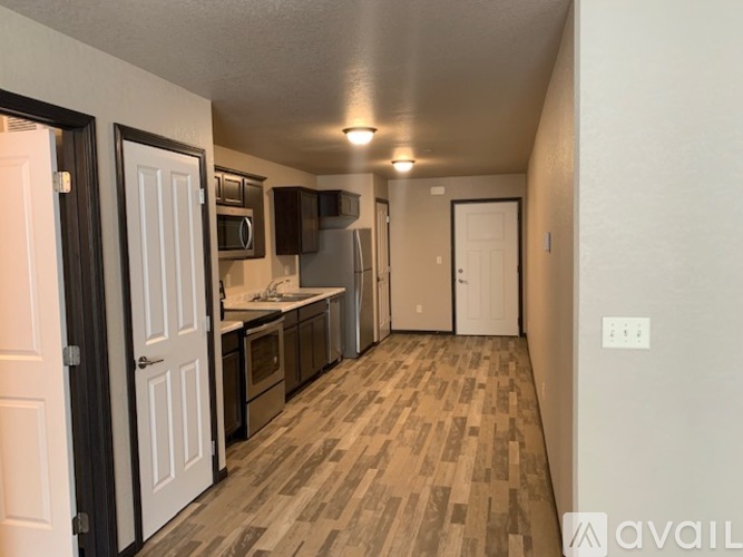 A kitchen with white cabinets and a microwave above the stove.