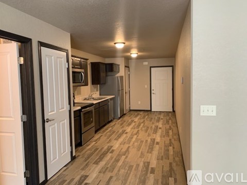 A kitchen with white cabinets and a microwave above the stove.
