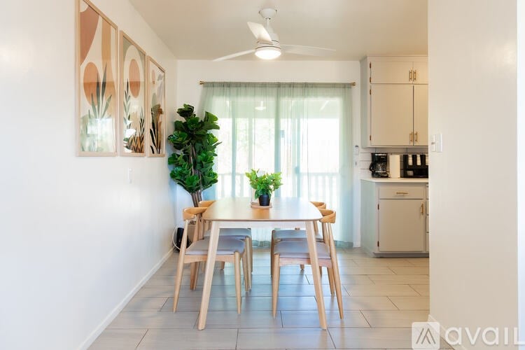 A dining room with a table and chairs.