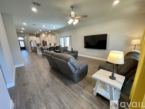 A living room with a grey couch and a white coffee table.