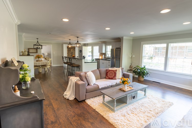 A living room with a couch, coffee table, and a television.