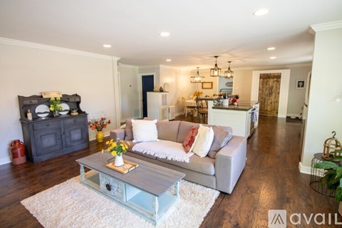 A living room with a grey couch and a coffee table.