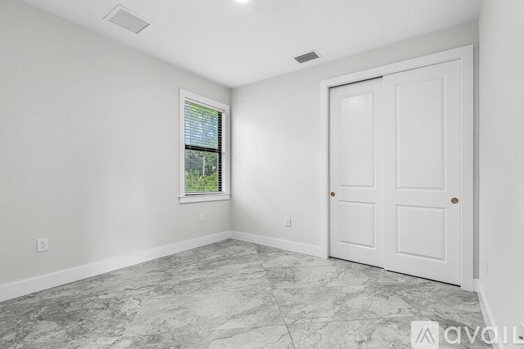 A room with a marble floor and a white door.