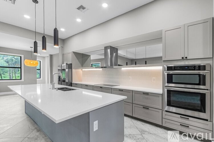 A modern kitchen with a large island in the center.