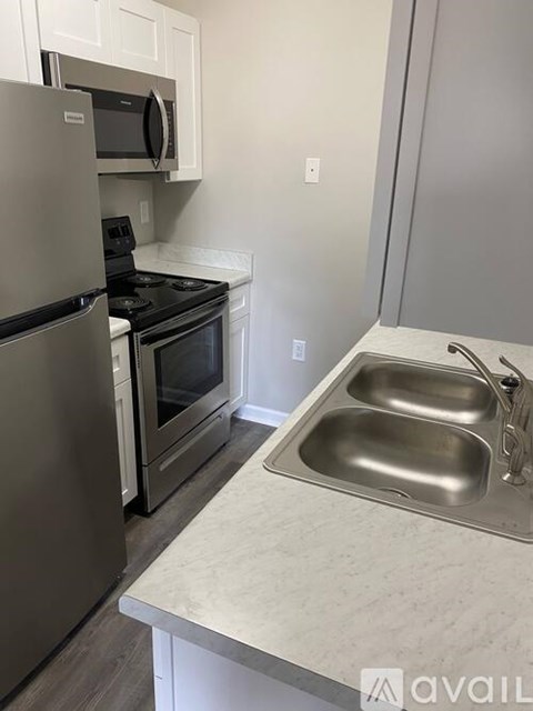A kitchen with a stainless steel refrigerator and oven.