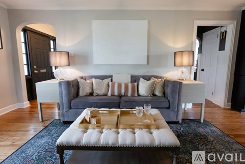 A living room with a grey couch and a coffee table.