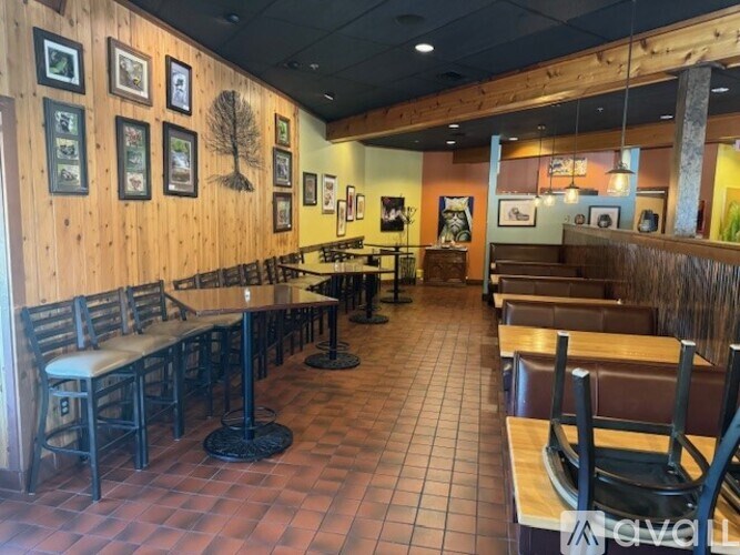 A restaurant with wooden booths and tables.