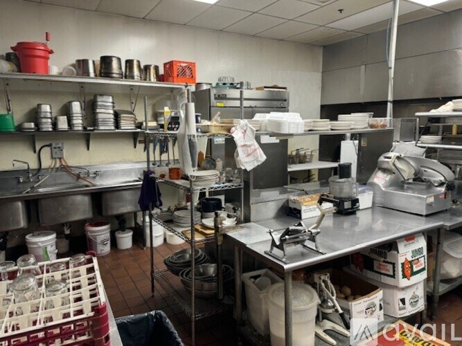 A kitchen with lots of cooking equipment and utensils.