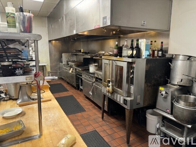 A kitchen with stainless steel appliances and a wooden table.
