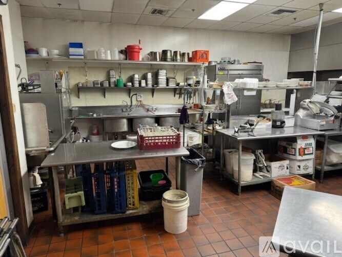 A kitchen with a lot of cooking equipment and utensils.