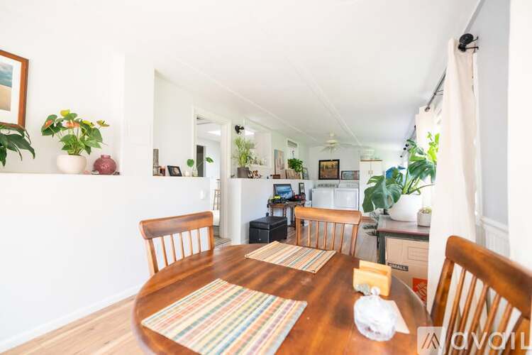 A dining room with a wooden table and chairs.
