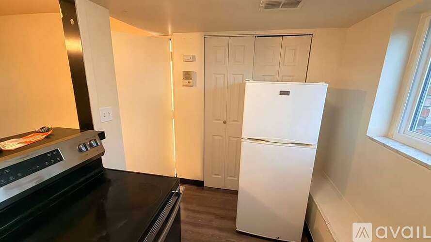 A kitchen with wooden cabinets and a white countertop.