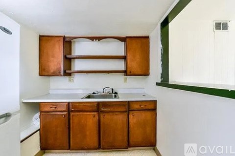 A kitchen with wooden cabinets and a white countertop.