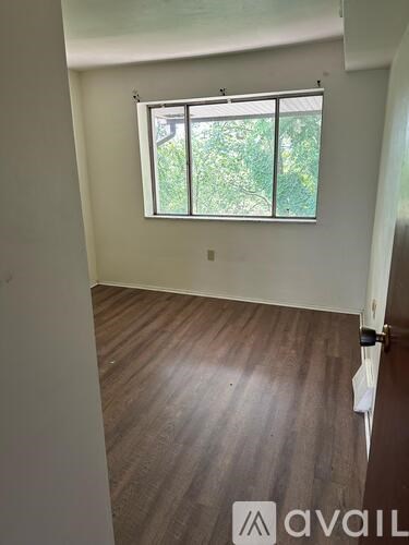 A room with a window and carpeted floor.