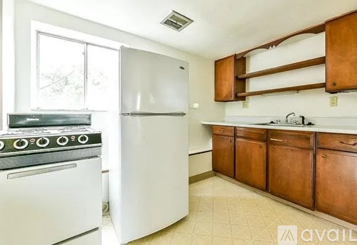 A kitchen with a white oven and refrigerator.